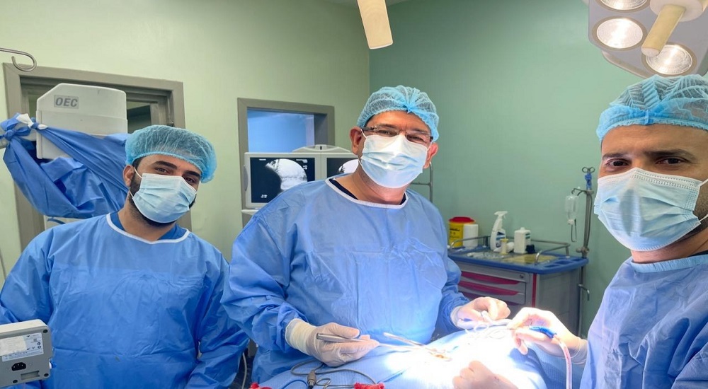 Performing a cervical spinal canal decompression surgery between the sixth and seventh cervical vertebrae at Dar Al-Tamreed Hospital.