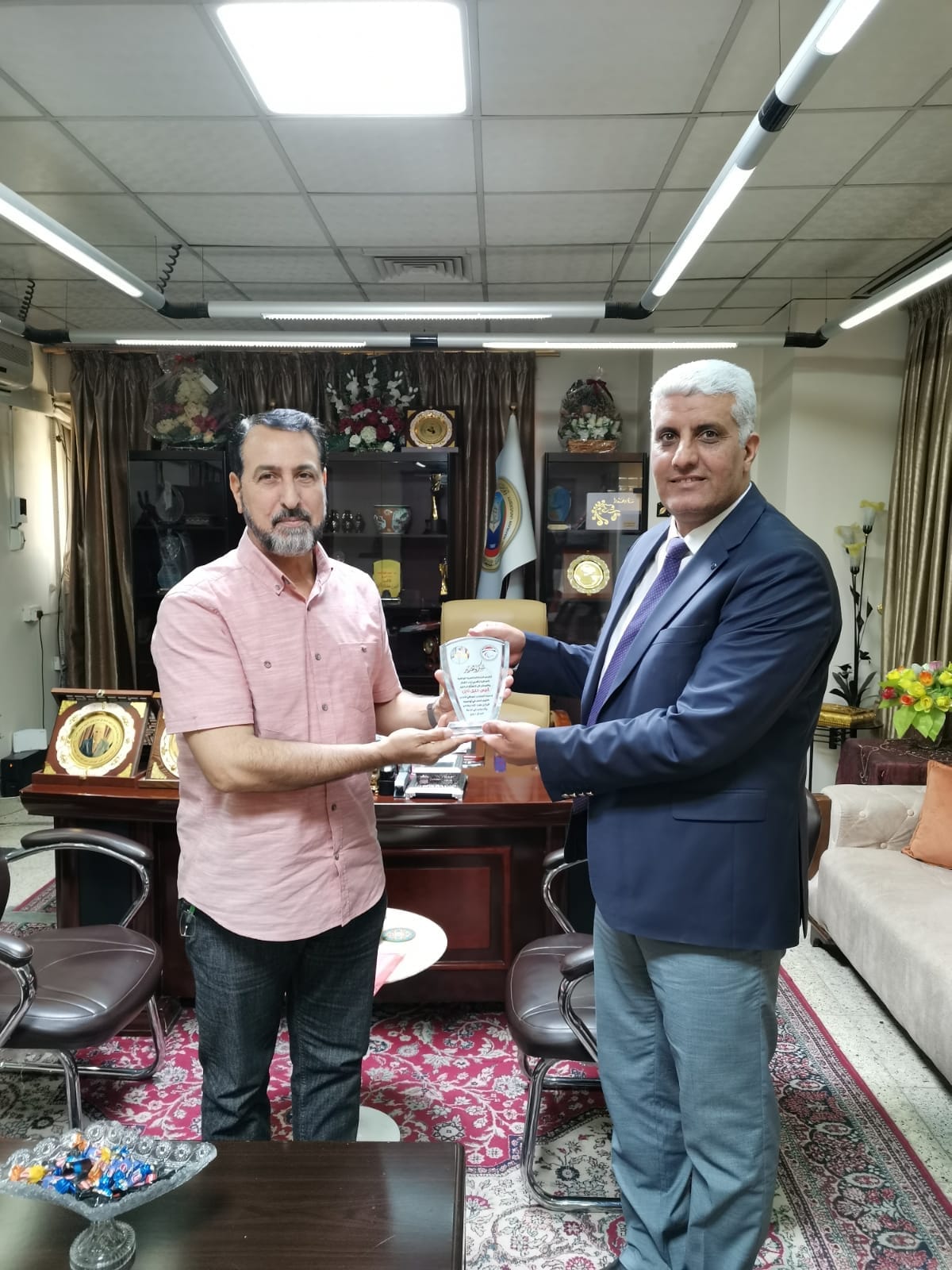 A shield for the Dean of Al-Nahrain College of Medicine presented by the Iraqi National Paralympic Committee - Iraqi Athletics Federation for the Deaf