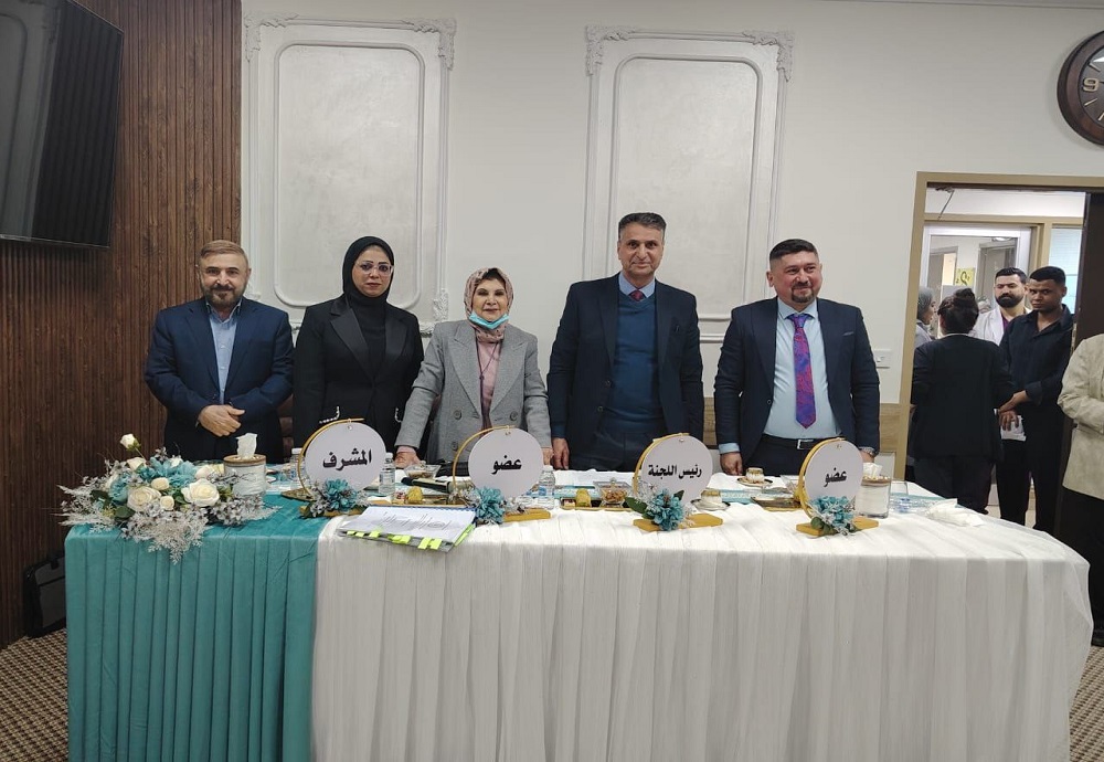 A faculty member from Al-Nahrain College of Medicine participates in the defense of a PhD dissertation on congenital heart diseases in patients with Down syndrome.